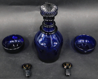 A 19thC Bristol Blue triple necked decanter, with mushroom shaped stopper, 25cm high, and two small Bristol Blue bowls, and two stoppers. (5) We have specific vendors instructions TO SELL WITHOUT RESERVE.