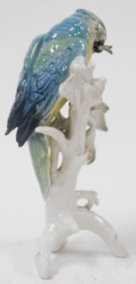 A Karl Ens porcelain figure of a parrot, modelled perched on a tree, with cherries, printed mark, 31.5cm high. - 2