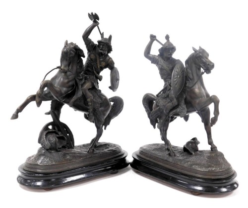 A pair of later 19thC spelter figures, modelled as warrior Goths on horseback, raised on an ebonised oval base, 32cm and 30cm wide.