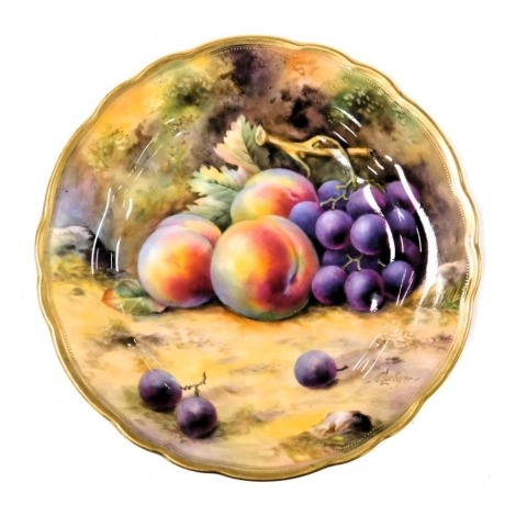 A Royal Worcester porcelain plate, circa 1924, painted by T Lockyer with peaches and grapes, signed, painted and printed marks, 23cm wide.