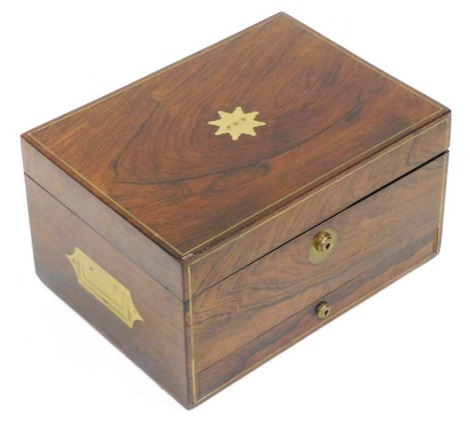 A Victorian rosewood workbox, with monogrammed brass escutcheon and line inlay, the hinged lid opening to reveal a red leather and velvet fitted interior, with fitted frieze drawer below, 17cm high, 31cm wide, 23cm deep.