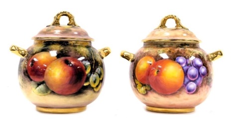 A pair of Royal Worcester porcelain vases and covers, of twin handled form, painted by Thomas, with fruit, printed marks, 9cm high.