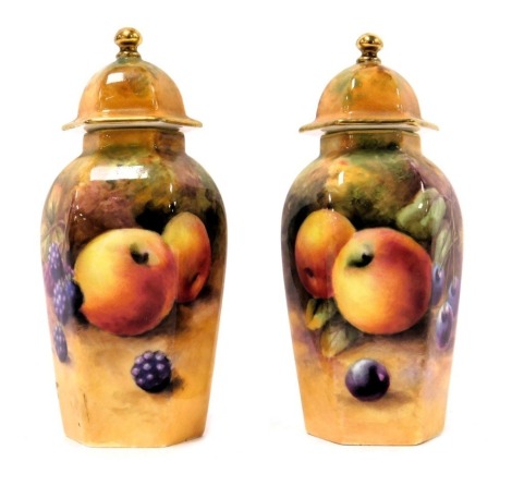 A pair of Royal Worcester porcelain vases and covers, circa 1924, of hexagonal form, painted with apples and blackberries, and apples and cherries, signed indistinctly, printed marks, 10.5cm high.