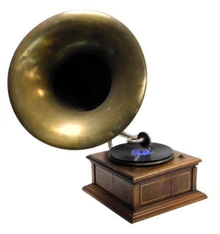 An early 20thC oak cased table top gramophone, with a brass horn.