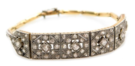 An Edwardian diamond six link bracelet, each pierced square link set with rose cut diamonds, set in yellow and white metal, on a snap clasp, 14.2g.