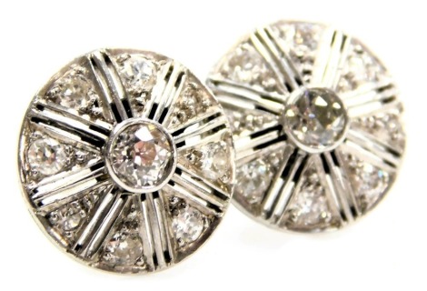 A pair of diamond earrings, of wheel form, set with rose cut diamonds, in white metal, with a pin fitting, the central diamonds approximately ½ct,