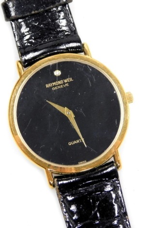 A Raymond Weil gentleman's 18ct gold plated wristwatch, circular black dial with diamond set at twelve, quartz movement, back numbered 5508-2, on a leather strap.