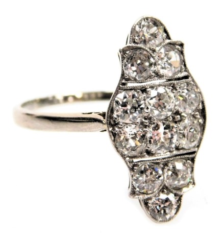 An Edwardian diamond ring, set with rose cut diamonds, in a serpentine shaped setting, in white metal, approximately ¾ct, size Q.