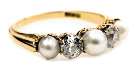 A diamond and pearl five stone ring, set with three graduated pearls and interspersed with two rose cut diamonds, in a yellow metal shank, stamped 18ct, diamonds approximately ½ct, size N, 3.5g.