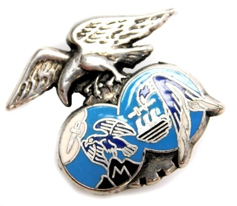 A Duffit and Co eagle badge, mounted over two turquoise discs, each depicting an eagle with sword, numbered A831, white metal unmarked, 3cm wide, 7g all in.