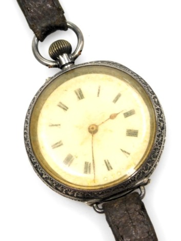 A 20thC pocket watch, converted to a wristwatch, with white enamel Roman numeric dial with gilt floral and star outer border, on bezel wind, white metal stamped 935, 36.7g all in. (AF)