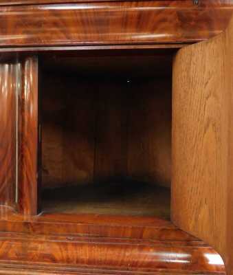 An early Victorian flame mahogany corner cupboard, with a shaped pediment over a serpentine door, flanked by turned columns, over a cushion drawer, panelled door enclosing two shelves, and further cushion drawer, flanked by turned columns, raised on a pli - 3