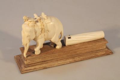 An early 20thC Indian ivory carving of an elephant pulling a log