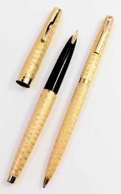 A Sheaffer pen set, comprising a fountain pen with 14ct nib and a ballpoint pen, each in gold coloured casing with a ribbed decoration, boxed. - 2