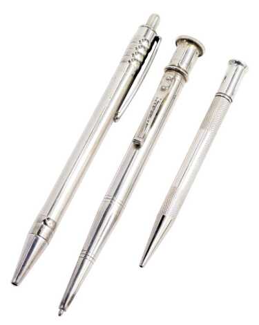 A silver cased propelling pencil, with engine turned decoration, together with a Yard O' Lead metal cased ball point pen and a Unoargento Italian ball point pen, marked 925.