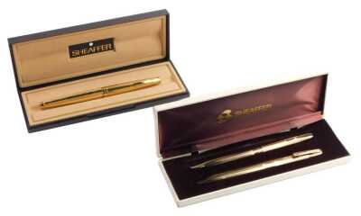 A Sheaffer fountain pen, in gold coloured part engine turned casing, 14ct nib, boxed, together with a Sheaffer ball point and pencil two piece set, in gold coloured ribbed casing, boxed.