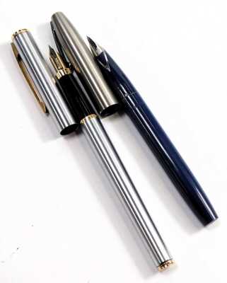 A Caran d'Ache ball point pen, in gold coloured engine turned decoration, together with an Elysee two pen set, in green, and two Sheaffer ball point pens. - 2