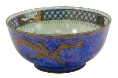 A Wedgwood dragon lustre bowl, on a blue ground decorated with dragons, with a pale blue centre, stamped Wedgwood, 21cm diameter.