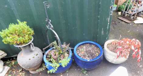 A group of garden wares, comprising two blue glazed garden planters, 31cm high, 52cm diameter, a terracotta Grecian style urn planter with two swing handles, 73cm high, a cast boot pull, 86cm high, and a reconstituted stone rose garden planter, 31cm high,