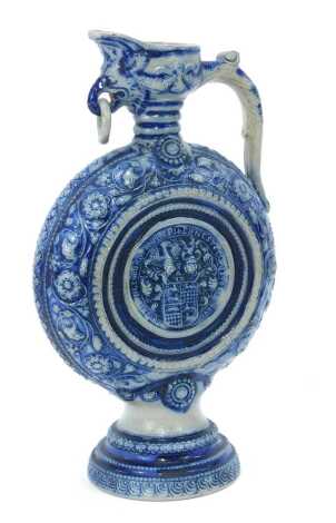 A Westerwald salt glazed jug, on a blue and grey patterned ground, with shield, 29cm high.