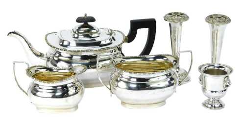 A silver plated three piece tea set, comprising teapot, milk jug, sugar bowl, each with a beaded border and ebonised handle, a pair of silver plated stem vases and a miniature Campana urn. (6)