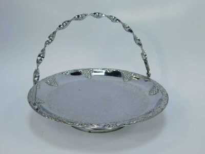 A group of silver plated table wares, comprising a two piece breakfast server, with glass inserts and silver plated rim, 11cm high, 30cm wide, two glass and silver rimmed serving dishes, 21cm wide, and a silver plated and berry design with swing handle, 2 - 4