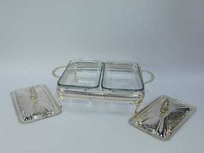 A group of silver plated table wares, comprising a two piece breakfast server, with glass inserts and silver plated rim, 11cm high, 30cm wide, two glass and silver rimmed serving dishes, 21cm wide, and a silver plated and berry design with swing handle, 2 - 5