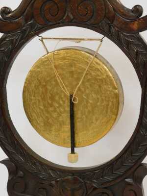 A Victorian oak and brass table gong, the large frame carved with leaves and scrolls, with brass central gong, on a rectangular base with claw feet, 125cm high, 80cm wide, 36cm deep. - 2