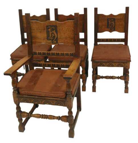 A set of four 20thC oak armchairs, comprising carver and three singles, each with carved and raised back bearing initials/shield possibly H, with later cushions. (4)