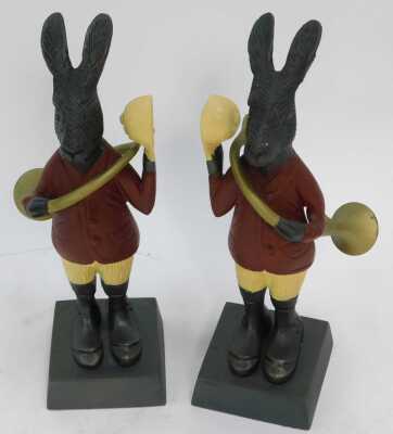 A pair of painted cast metal figures, each modelled as a hare with a musical instrument, 22cm high. - 2