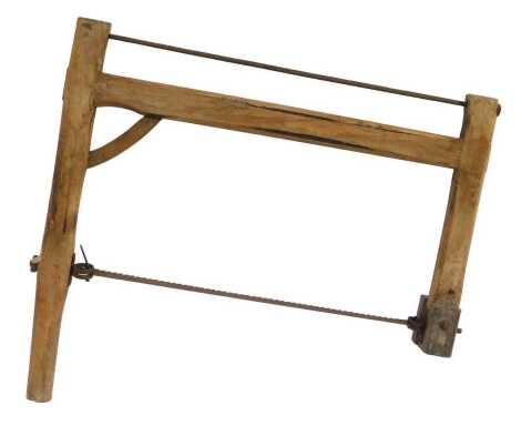 A stone saw, wooden framed with steel blade, 70cm wide.