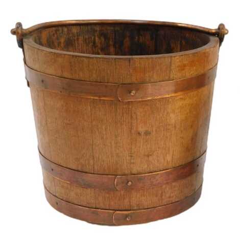 An oak coal bucket, with copper banding and ring handle, containing a galvanised metal liner, 32cm wide.