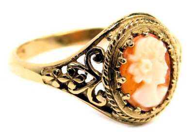 A 9ct gold shell cameo dress ring, the oval cameo claw set, with scroll floral shoulders, ring size N½, 2.2g all in.