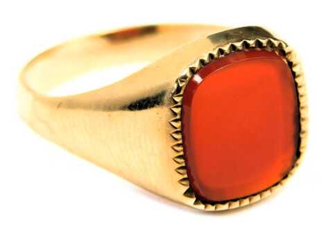 A 9ct gold signet ring, set with rectangular cut orange agate, and a zigzag border, maker FM, London 1971, ring size X½, 4.8g all in.