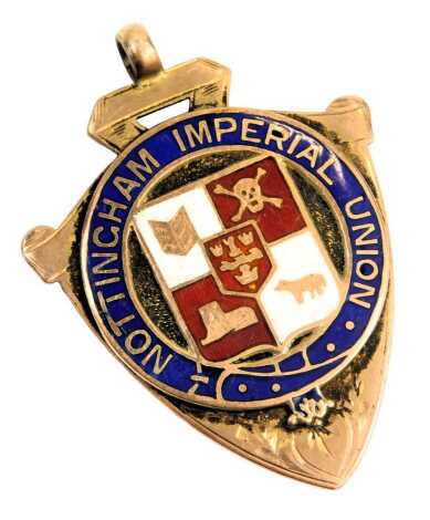 A 9ct gold shield fob, enamel decorated inscribed Nottingham Imperial Union, retailer Homad Pattorin of Hockley Street Birmingham, 8.7g.