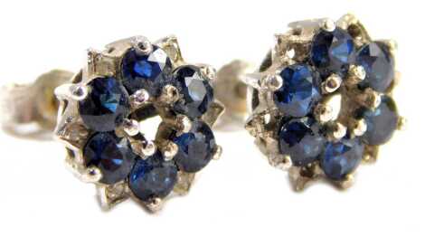 A pair of 9ct gold sapphire and diamond cluster earrings, each on a white metal backing, with a halo of six sapphires, lacking centre stones, on single pins with butterfly backs, unmarked, 3.4g all in. (AF)