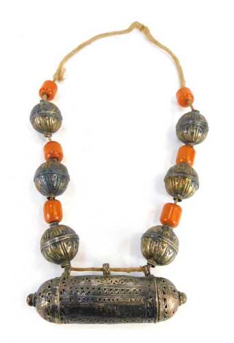 An Eastern Prayer necklace, the knotted string strand with applied bulbous design, with butterscotch amber beads, 2.5cm long, the bulbous beads 5cm wide, lower prayer wheel 15cm wide, white metal unmarked, 342.4g all in.