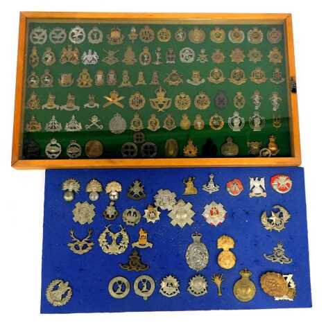 Two military cap badge displays, comprising shoulder cuffs, deer and stag, Connaught Ranges, First Hand Volunteers and others. (2)