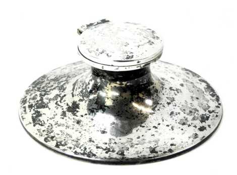 An Elizabeth II silver Capstan inkwell, with ceramic well, on a weighted and leatherette base, Birmingham 1971.