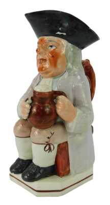 A 19thC pottery Toby jug, modelled as a seated gentleman wearing a tricorn hat holding a tankard of beer and pipe, 26cm high.