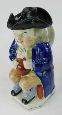 A 19thC pottery Toby jug, modelled as a seated gentleman wearing a tricorn hat, with a lid, holding a tankard containing beer and pipe, 24cm high. - 2