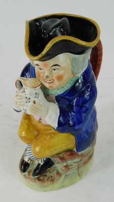 A 19thC pottery Toby jug, modelled as a seated gentleman wearing a tricorn hat with lid, grasping a tankard of beer, 25cm high. - 2