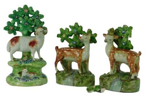 A 19thC Walton Staffordshire pottery figure group, depicting a ram and a lamb, 18.5cm high, together with a pair of Staffordshire pearlware figures depicting a deer and a stag, 15.5cm high. (AF)