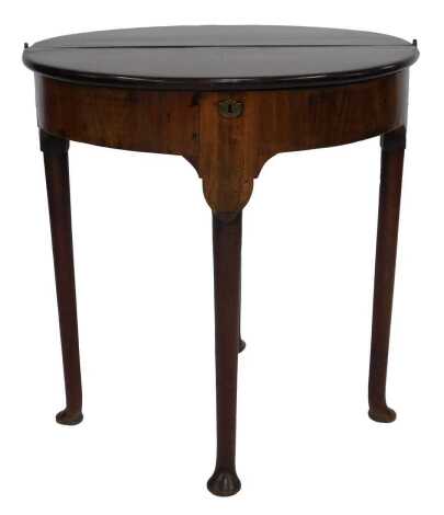 A Georgian mahogany D end tea table, with brass escutcheon, raised on four turned tapering legs, on pad feet, 72cm high, 63cm wide, 35cm deep.