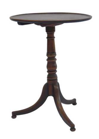 A 19thC mahogany tripod table, circular dish top above a cylindrical turned column on out splayed legs and compressed bun feet, 72cm high, the top 53.5cm diameter.