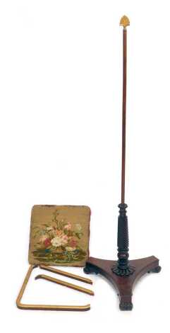 A Victorian mahogany pole screen stand, the top with a gilded fan shaped finial, on cylindrical column with floral embroidered panel, on a spiral turned column, on shaped triangular base with three scrolling feet, 158cm high. (AF)