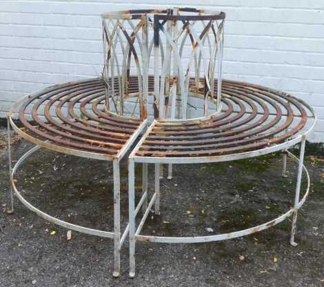 A wrought iron and cream painted garden tree bench, splitting in two sections, the centre 54cm diameter. (AF)