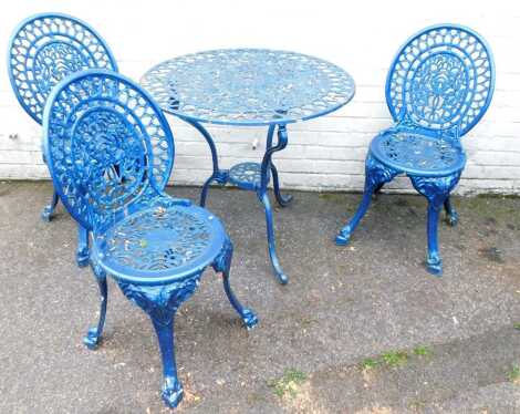 A cast aluminium garden table and three chairs, over painted in metallic blue, 70cm high, 76cm diameter. (4)