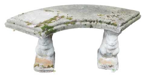 A reconstituted stone garden bench, on squirrel rectangular supports, with a curved top, 51cm high, 98cm wide, 33cm deep.