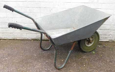 A galvanised wheelbarrow.